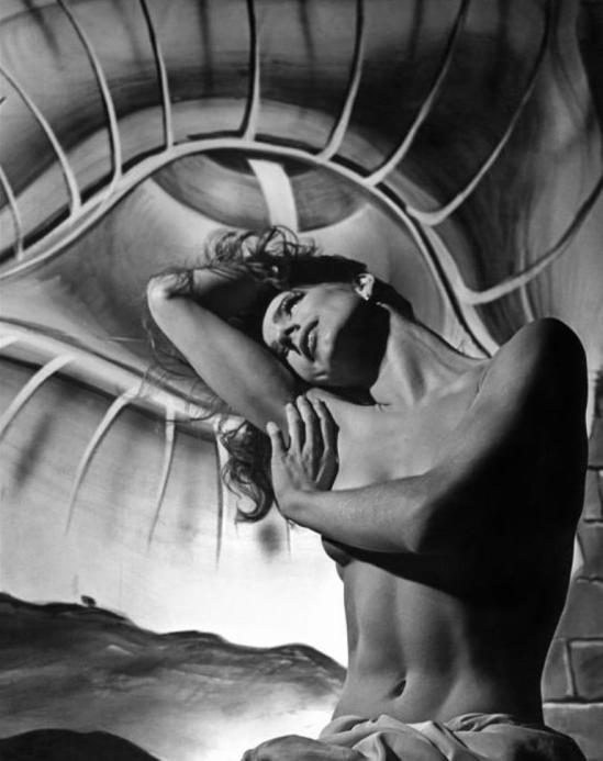 Philippe Halsman. Toni Hollingsworth with a Dali painting in the background 1945 Via magumphotos