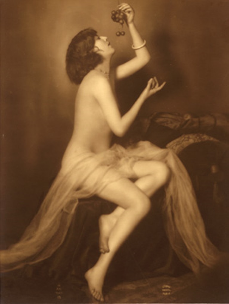 Armand Noyer (At the Mandel Studio). A seated female holding grapes above her face 1925-1930