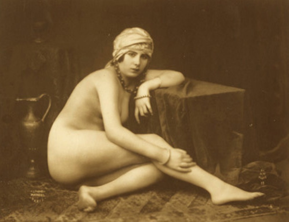 Armand Noyer (At the Mandel Studio). A women seated on the floor with her arm on a table 1925-1935