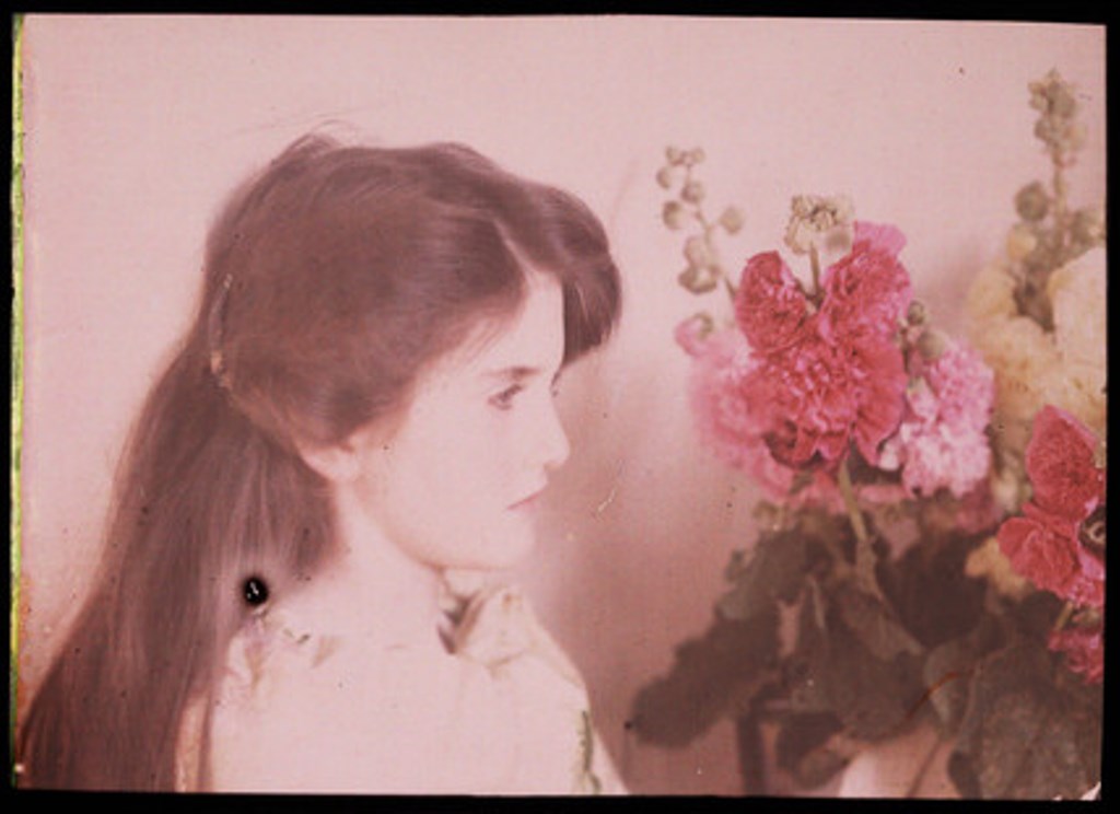 Etheldreda Janet Laing. Young girl looking at a vase of flowers 1910. Autochrome ® National media museum