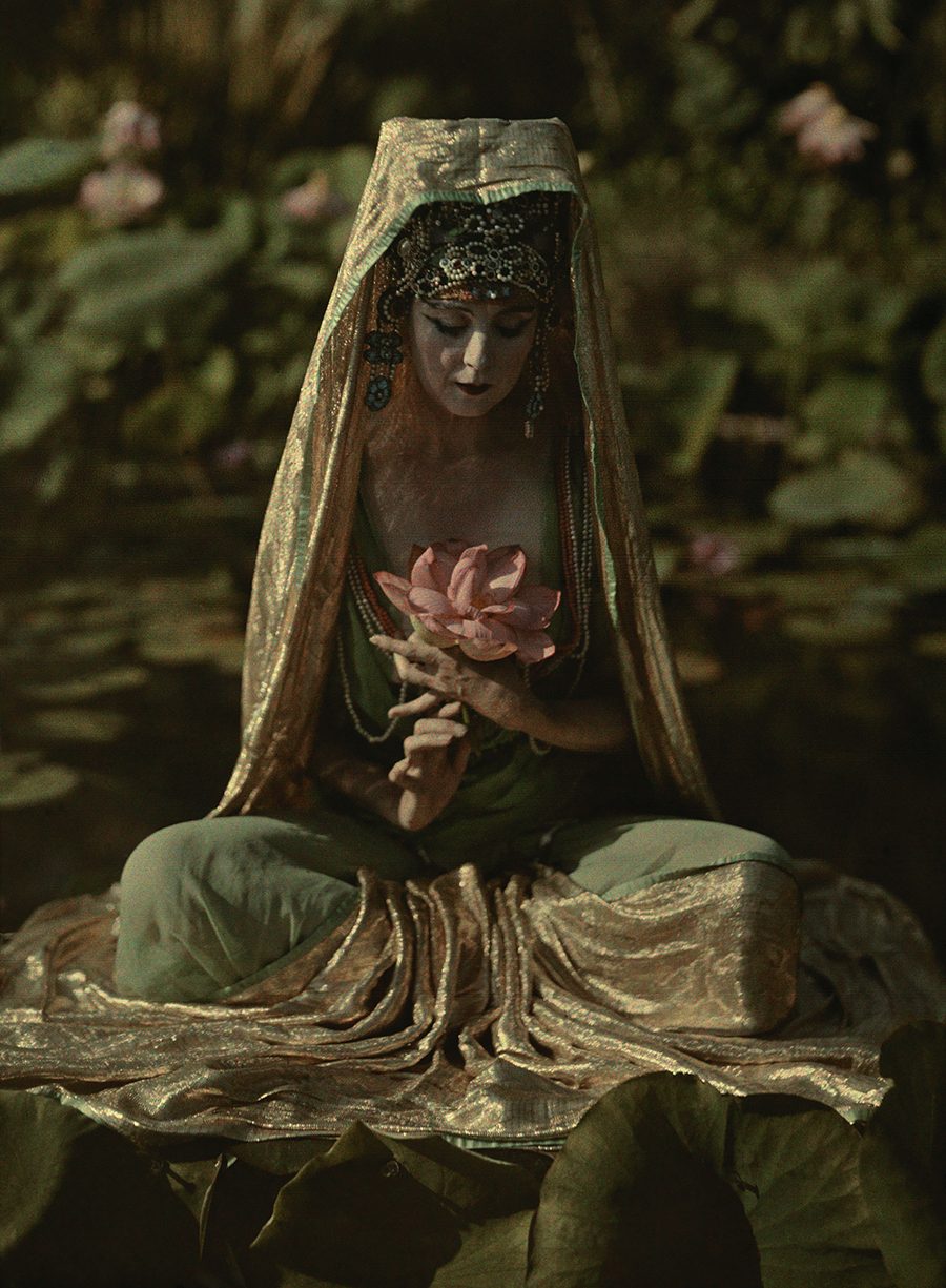 Franklin Price Knott. Woman adorned like a chinese goddess poses in a garden in California 1915. AutochromeVia National Geographic