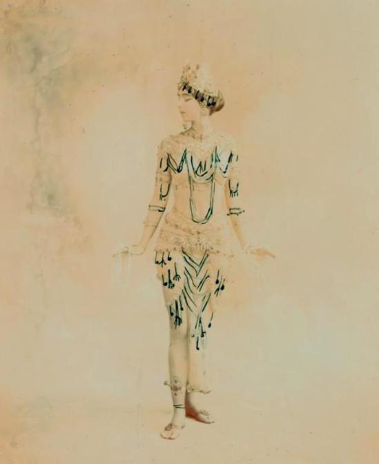 Ruth St. Denis in Radha, transitional costume with black tracings indicating added jeweled pendants. Via nypl