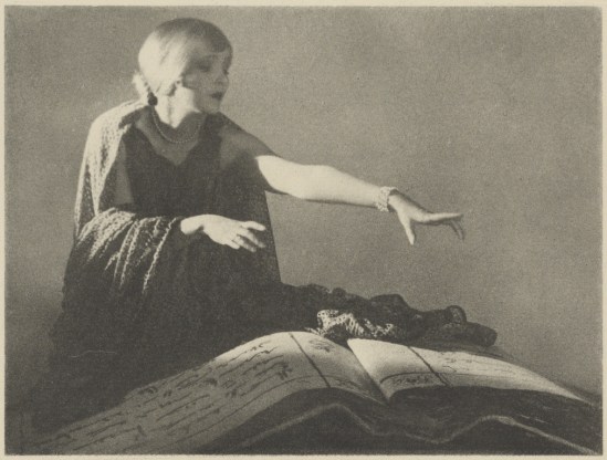 Arthur F. Kales. Woman Reaching Out Over a Large Book 1920. Via getty